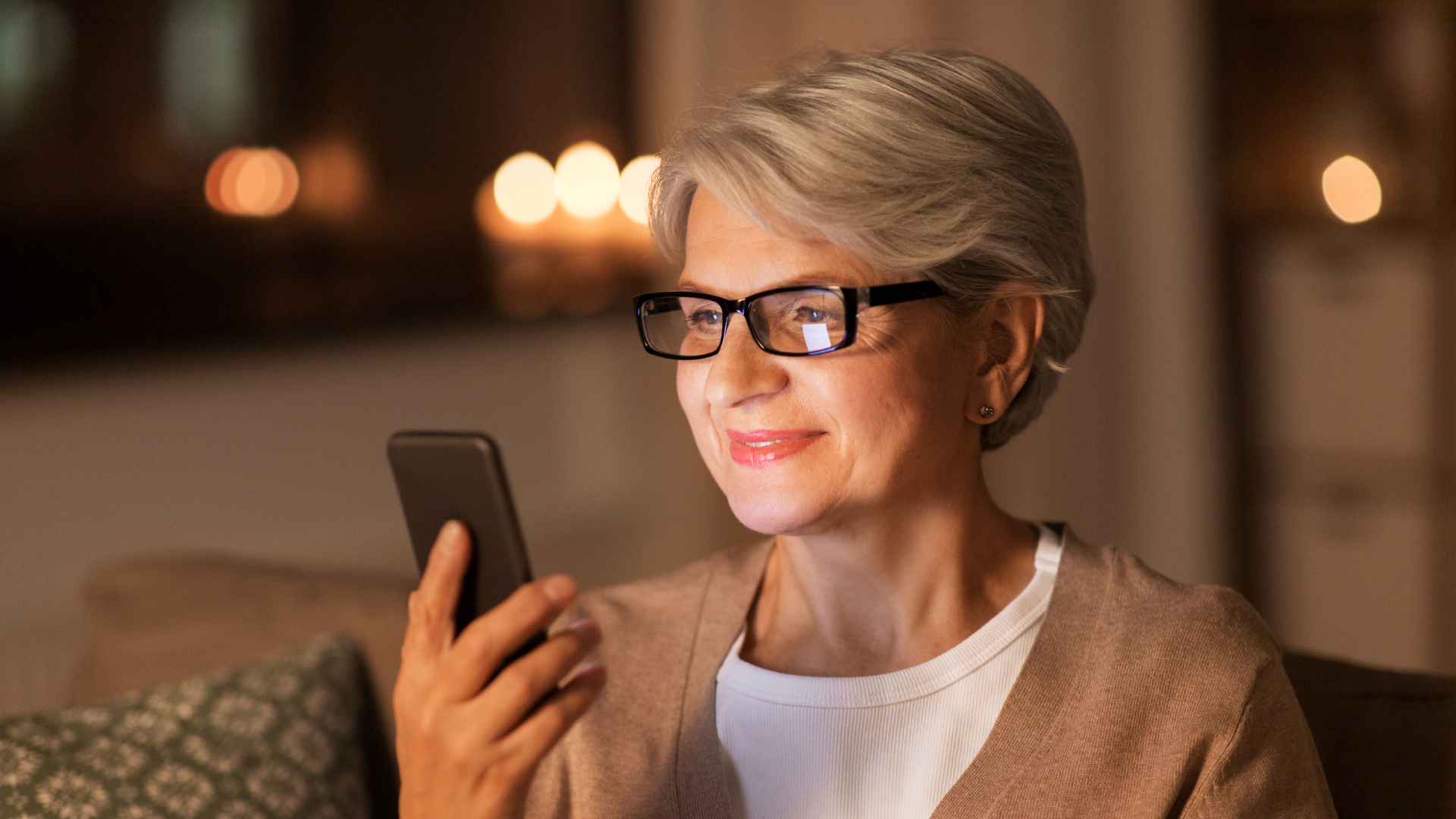 Woman smiling while using NOMI app on smartphone